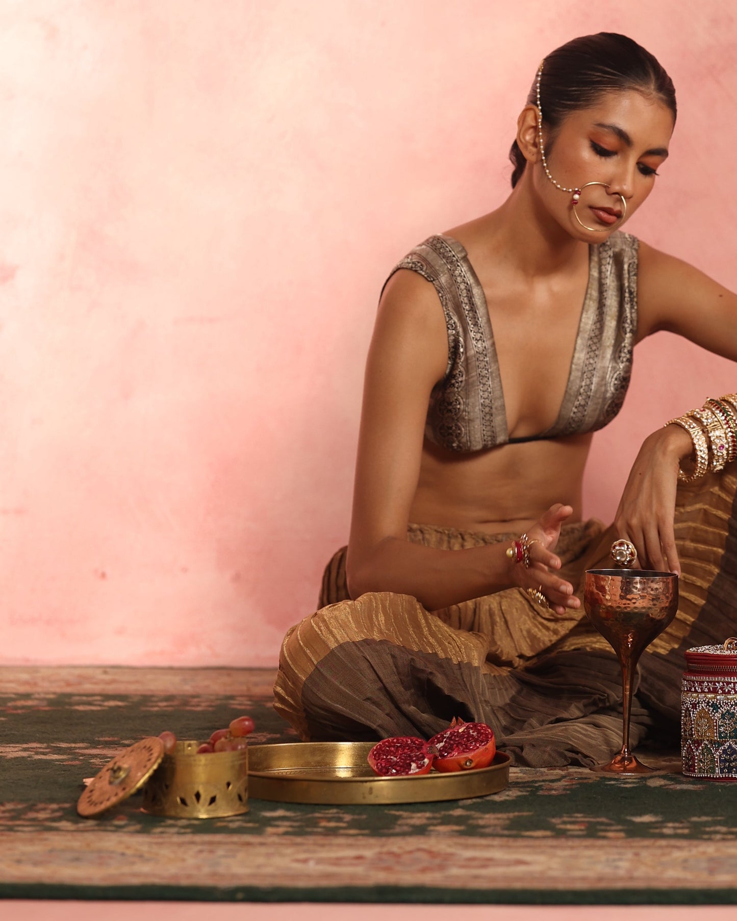 Brass accessories home styling with brass box, tealights and copper goblet or glass for wine