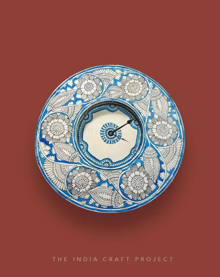Neela Bageecha hand-painted Tholu wall clock showcasing vibrant blue garden motifs for a colorful and artistic accent