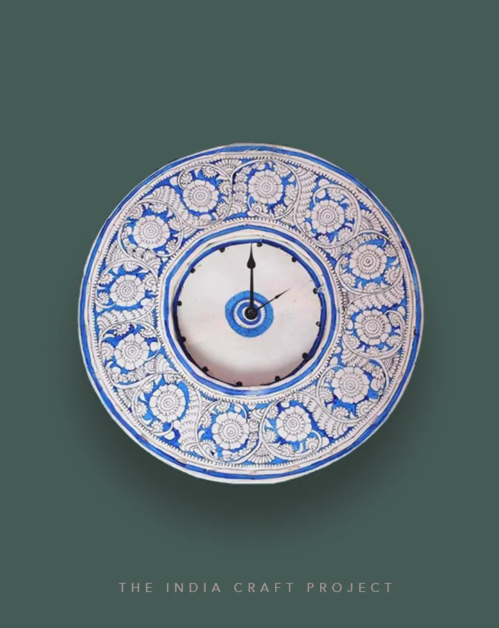 Neela Baag hand-painted Tholu wall clock with vibrant blue floral and leafy patterns, perfect for colorful interiors