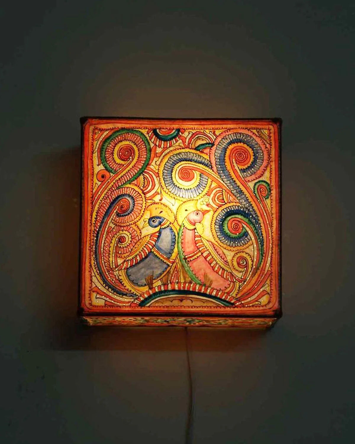 Chhaya hand-painted Tholu wall lamp with intricate patterns, offering a blend of art and soft ambient lighting