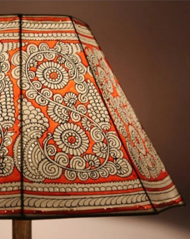 Narangi hand-painted Tholu lampshade with bright orange floral patterns, adding a lively touch to your decor