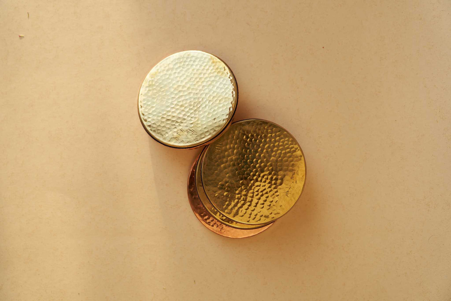 Chamak copper and brass coasters, set of 4, featuring a sleek handcrafted design for elegant table settings