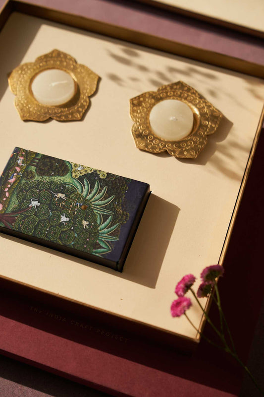 Ramya gift box featuring Chidiya brass tealight holders and TICP playing cards, a unique handcrafted gift set