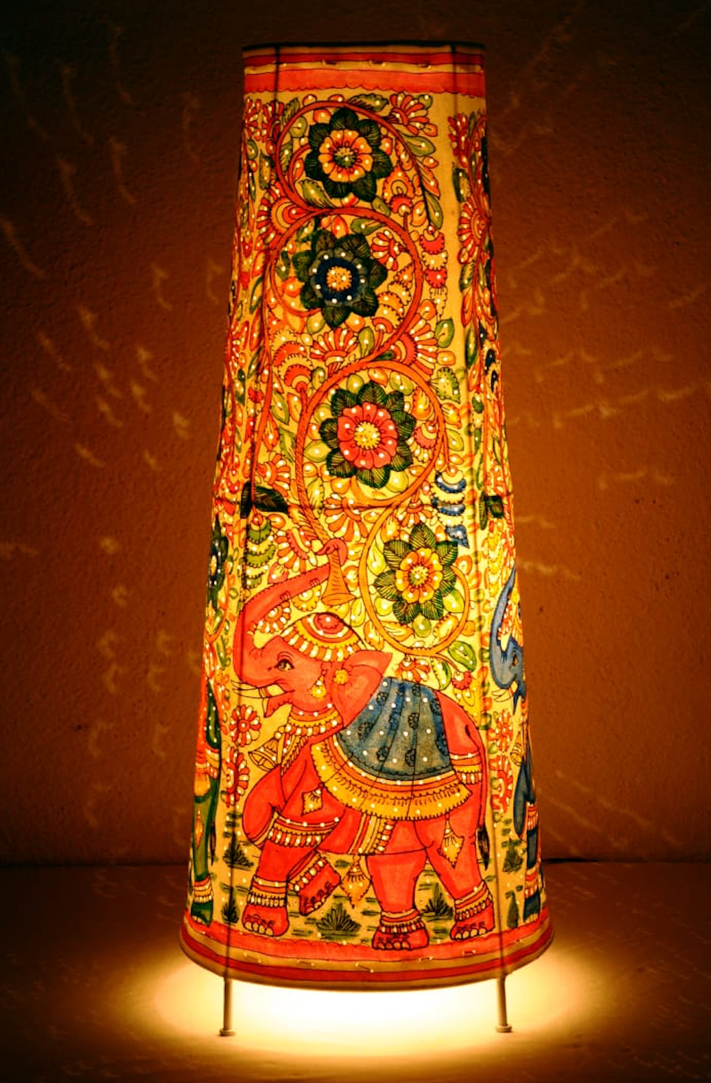Gajraaj hand-painted Tholu tall corner lamp with intricate elephant designs, a striking artisan piece for ambient lighting