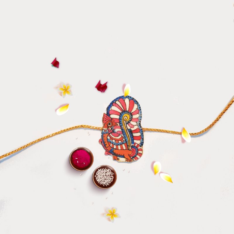 Tholu Bommalata rakhis handcrafted with traditional Tholu art, featuring intricate detailing for festive celebrations