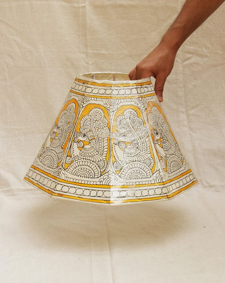 Sunehra hand-painted Tholu lampshade with golden floral accents, adding a luxurious and warm glow to any space